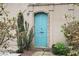 Charming rustic blue door framed by lush greenery and stonework at 440 Old Homestead Trl, Johns Creek, GA 30097