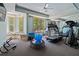 Exercise room featuring exercise equipment, light blue walls, and windows with natural light at 440 Old Homestead Trl, Johns Creek, GA 30097
