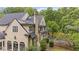 Exterior elevation of home showing stone chimney, stucco, and professionally landscaped yard at 440 Old Homestead Trl, Johns Creek, GA 30097