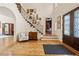 Grand two-story foyer with elegant hardwood floors, arched doorways and custom millwork, creating a welcoming entrance at 440 Old Homestead Trl, Johns Creek, GA 30097