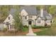 Stunning stone home boasts lush landscaping and a welcoming front entrance with a classic design at 440 Old Homestead Trl, Johns Creek, GA 30097