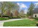 Beautifully landscaped front yard with mature trees and manicured shrubbery at 440 Old Homestead Trl, Johns Creek, GA 30097
