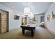 Game room with billiard table, mounted TV, and stone archway that leads to other rooms at 440 Old Homestead Trl, Johns Creek, GA 30097