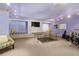 Recreational room includes a ping pong table, a drumset, and built-in seating under soft lighting at 440 Old Homestead Trl, Johns Creek, GA 30097