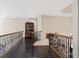 Upstairs hallway with hardwood floors, detailed railings, and a built-in bookcase at 440 Old Homestead Trl, Johns Creek, GA 30097