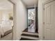 Hallway with steps, leading to an open area with hardwood flooring and a decorated doorway at 440 Old Homestead Trl, Johns Creek, GA 30097