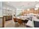 Bright eat-in kitchen with a dining table, island seating, modern light fixtures, and lots of natural light at 440 Old Homestead Trl, Johns Creek, GA 30097