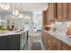 Bright kitchen with large island, stainless steel sink, white marble countertops, wooden cabinets, and stainless steel appliances at 440 Old Homestead Trl, Johns Creek, GA 30097