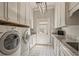 Clean and functional laundry room with modern appliances, countertops, and cabinet space at 440 Old Homestead Trl, Johns Creek, GA 30097