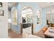 Arched doorways into living room with coffered ceiling, chandelier, and ample light from large windows at 440 Old Homestead Trl, Johns Creek, GA 30097