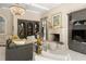 Spacious living room featuring custom built-ins, a stone fireplace, large windows, and stylish furniture at 440 Old Homestead Trl, Johns Creek, GA 30097