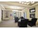 Comfortable living area features a fireplace, TV and plush armchairs under a decorative ceiling at 440 Old Homestead Trl, Johns Creek, GA 30097