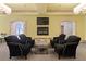 Inviting living room with black armchairs, fireplace, and stone archways to other rooms at 440 Old Homestead Trl, Johns Creek, GA 30097