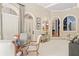 Open concept living room with arched doorways, leading to an outdoor space and other rooms at 440 Old Homestead Trl, Johns Creek, GA 30097