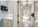Spacious mud room with tile floors, white cabinets, drawers, a hanging light fixture, and an exterior door at 440 Old Homestead Trl, Johns Creek, GA 30097