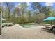 Resort-style pool area with a patio, spa, lounge chairs, outdoor seating, and lush landscaping at 440 Old Homestead Trl, Johns Creek, GA 30097