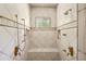 Large tiled shower with dual shower heads and built-in bench at 440 Old Homestead Trl, Johns Creek, GA 30097