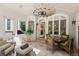 Charming sunroom featuring wicker seating, tiled floors, and bright light at 440 Old Homestead Trl, Johns Creek, GA 30097