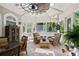 Bright sunroom featuring stylish hanging lanterns and comfortable wicker furniture, perfect for relaxation at 440 Old Homestead Trl, Johns Creek, GA 30097