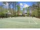 A well-maintained tennis court with a gazebo, surrounded by lush trees at 440 Old Homestead Trl, Johns Creek, GA 30097