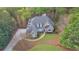 An aerial view of a home featuring mature landscaping and a private lot at 8385 Sentinae Chase Dr, Roswell, GA 30076