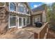 Back deck with multiple doors to the interior and a grill at 8385 Sentinae Chase Dr, Roswell, GA 30076