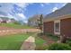 A stone path leads through the backyard with mature landscaping and stone retaining wall at 8385 Sentinae Chase Dr, Roswell, GA 30076