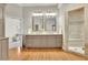Elegant bathroom featuring double vanity, a large walk-in shower, and hardwood floors at 8385 Sentinae Chase Dr, Roswell, GA 30076