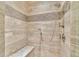 Tile shower featuring a bench, dual shower heads and glass door at 8385 Sentinae Chase Dr, Roswell, GA 30076
