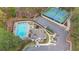Aerial view of the community pool and tennis courts in a wooded setting at 8385 Sentinae Chase Dr, Roswell, GA 30076