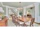 Formal dining room showcasing hardwood floors, a large chandelier, and elegant trim at 8385 Sentinae Chase Dr, Roswell, GA 30076