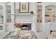 White fireplace flanked by custom built-in bookshelves at 8385 Sentinae Chase Dr, Roswell, GA 30076