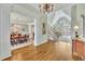 Inviting foyer with hardwood floors, staircase, chandelier, and views into the formal dining room and living areas at 8385 Sentinae Chase Dr, Roswell, GA 30076