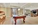 Bright game room with a billiard table, bar seating, and comfortable lounge area for entertainment at 8385 Sentinae Chase Dr, Roswell, GA 30076