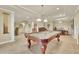 Spacious game room with a billiard table and traditional-style decor, including a piano and tile flooring at 8385 Sentinae Chase Dr, Roswell, GA 30076