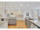Spacious kitchen with kitchen island, modern appliances, and granite counters at 8385 Sentinae Chase Dr, Roswell, GA 30076