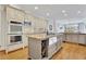 Kitchen features large kitchen island with granite counters and stainless steel appliances at 8385 Sentinae Chase Dr, Roswell, GA 30076