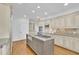 Spacious kitchen features a large kitchen island with gas cooktop and granite counters at 8385 Sentinae Chase Dr, Roswell, GA 30076