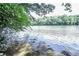 A view of the lake from a wooded area at 8385 Sentinae Chase Dr, Roswell, GA 30076