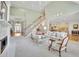 Open-concept living room with fireplace, staircase and kitchen views at 8385 Sentinae Chase Dr, Roswell, GA 30076