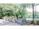 Park benches are situated along a path with views of the river at 8385 Sentinae Chase Dr, Roswell, GA 30076