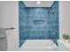 This remodeled bathroom has blue tiled walls and modern shower head at 1 N Boundary Nw Pl, Atlanta, GA 30318