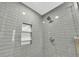 Designer shower featuring gray subway tile with decorative niche, modern fixtures, and glass door at 1 N Boundary Nw Pl, Atlanta, GA 30318