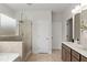 Modern bathroom with a glass enclosed shower, double sink, and tiled floor at 1455 Auburn Glen Rd, Dacula, GA 30019