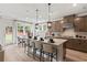 Modern kitchen features a large island with seating and views of the backyard through multiple windows at 1455 Auburn Glen Rd, Dacula, GA 30019