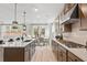 Modern kitchen boasts stainless steel appliances, a spacious island, and an open layout at 1455 Auburn Glen Rd, Dacula, GA 30019