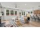 A living room and kitchen combination features multiple windows providing natural light and a view of the backyard at 1455 Auburn Glen Rd, Dacula, GA 30019