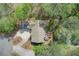 Aerial view of a well-maintained home featuring a paved driveway, beautiful landscaping, and a backyard deck at 201 Rippling Nw Dr, Marietta, GA 30064