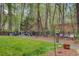 Expansive backyard featuring a stone path leading to a fire pit and wooded area at 201 Rippling Nw Dr, Marietta, GA 30064