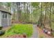 Spacious backyard with fire pit area, surrounded by lush trees and greenery at 201 Rippling Nw Dr, Marietta, GA 30064